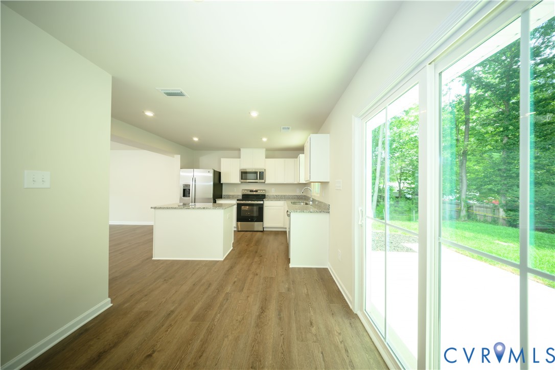 1121 Canterbury Ridge Road Richmond, VA 23224 - Photo 21 of 53 Open-concept kitchen and living area featuring woo