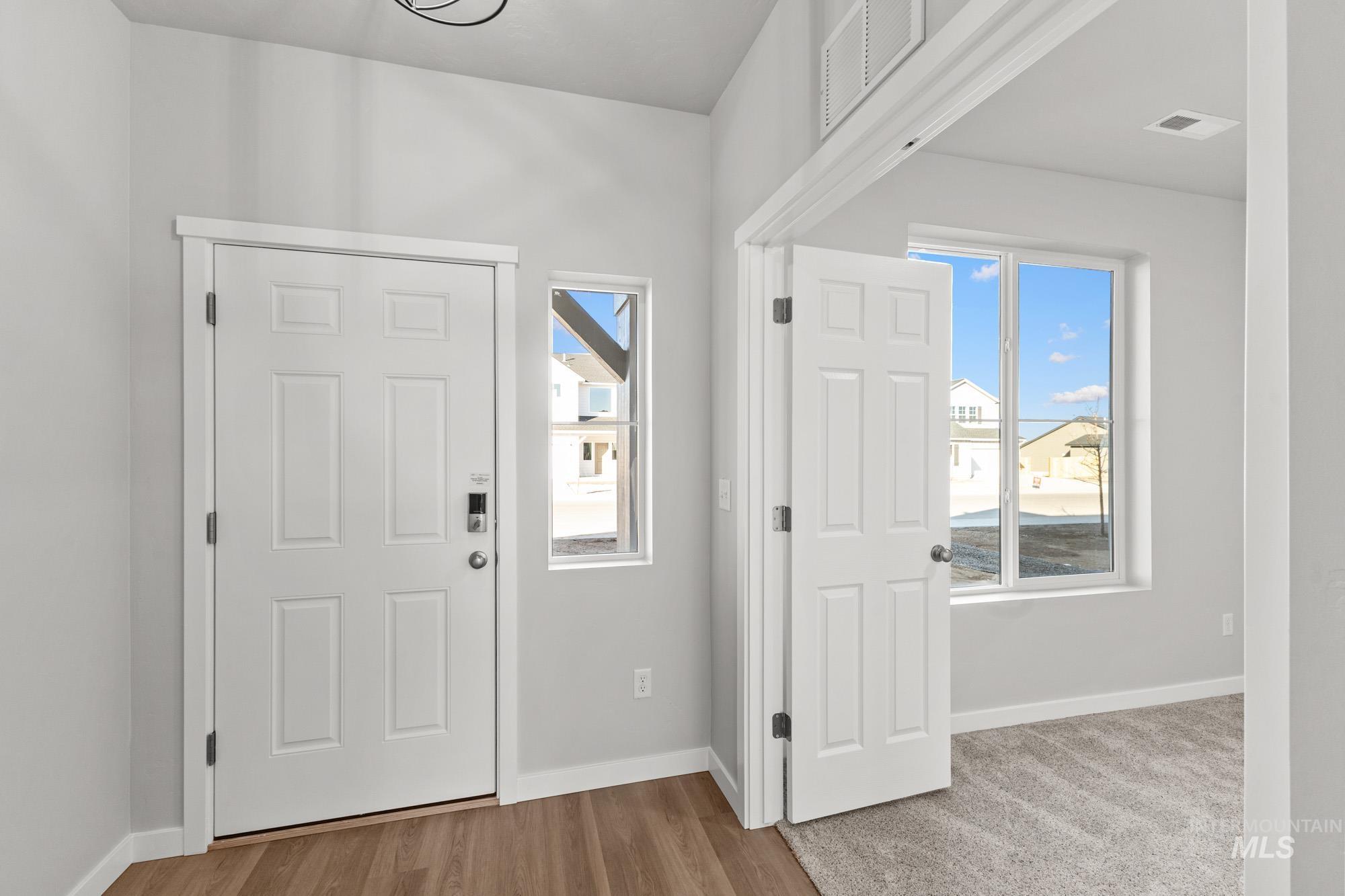 13713 Judson Street Caldwell, ID 83607 - Photo 2 of 24 Foyer entrance with light wood finished floors and plenty of natural light