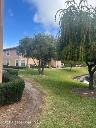 an empty room with wooden floor a ceiling fan and a window
