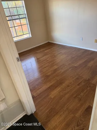 a view of a livingroom with a ceiling fan and window