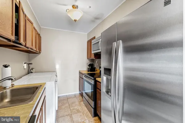 a kitchen with refrigerator and cabinets