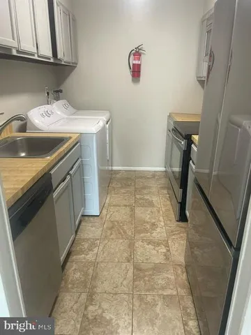 a utility room with a sink a washer and dryer