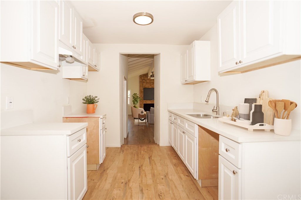 706 North Tajauta Avenue Compton, CA 90220 - Photo 4 of 13 a kitchen with a sink stove and cabinets