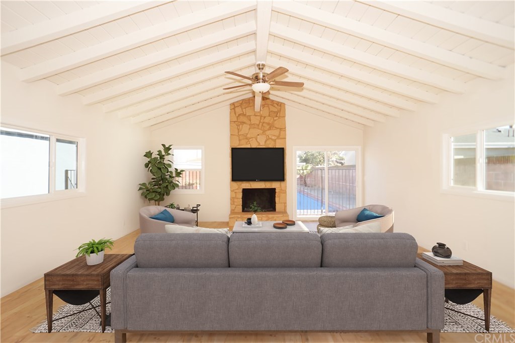 706 North Tajauta Avenue Compton, CA 90220 - Photo 7 of 13 a living room with furniture a fireplace and a chandelier