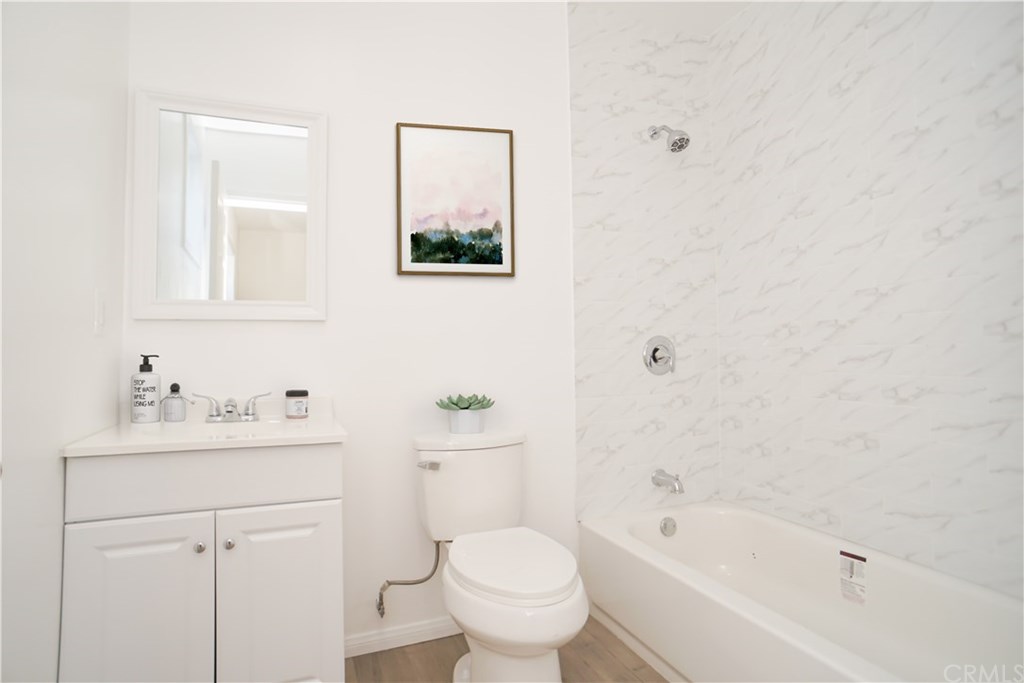 706 North Tajauta Avenue Compton, CA 90220 - Photo 10 of 13 a bathroom with a toilet sink and mirror