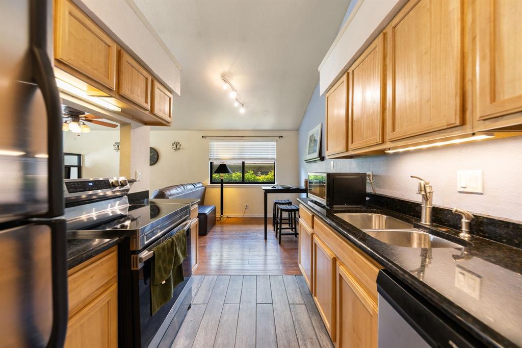 2240 Tarpley Road, Unit 411 Carrollton, TX 75006 - Photo 9 of 28 a kitchen with stainless steel appliances a sink dishwasher stove and oven