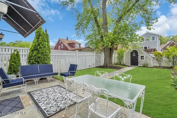 a view of a livingroom with wooden furniture and staircase