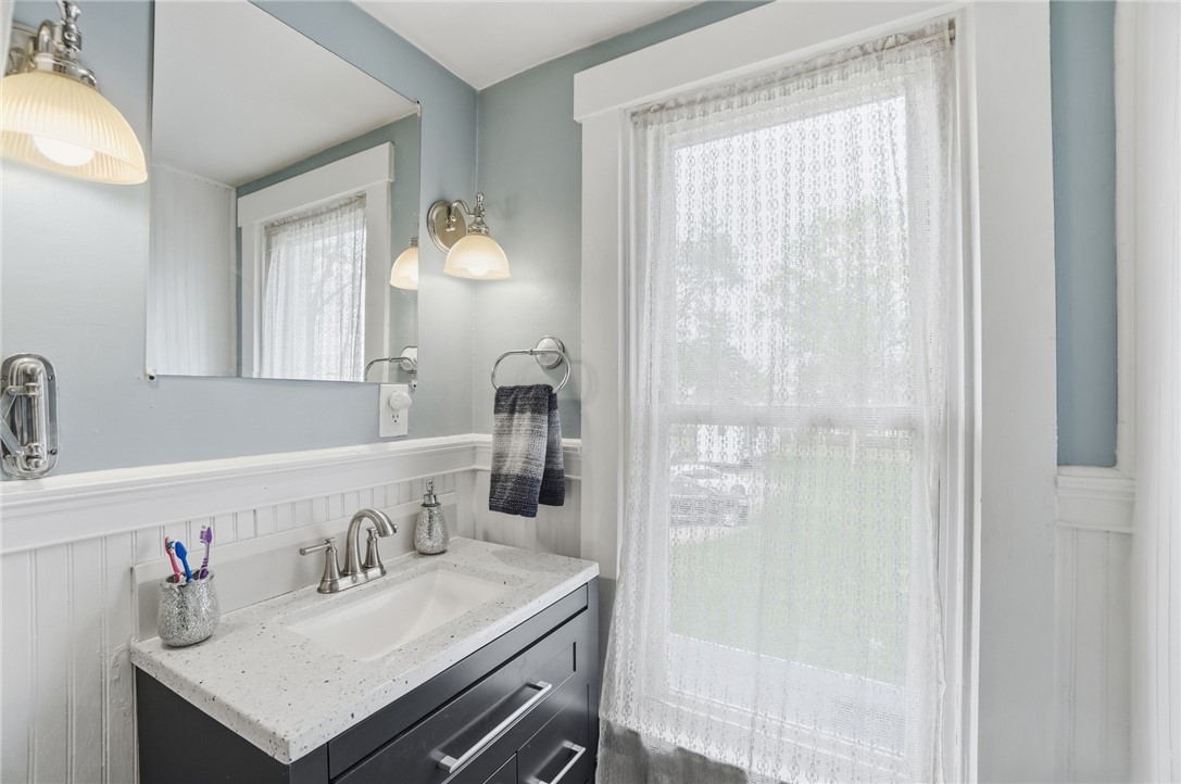 6155 North Union Road Clayton, OH 45315 - Photo 34 of 59 This bright bathroom features a vanity with a sleek countertop and a large window.