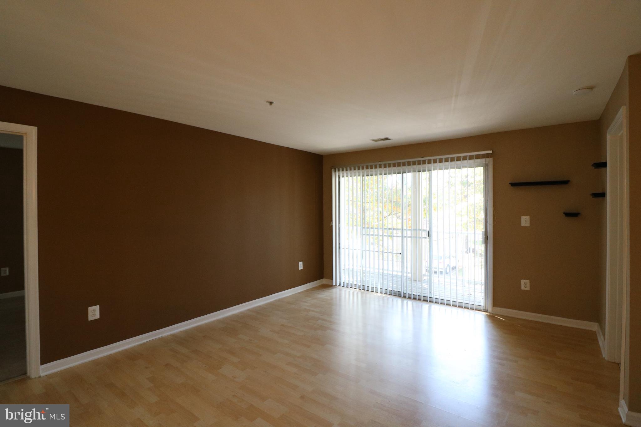 18701 Sparkling Water Drive, Unit 13H Germantown, MD 20874 - Photo 12 of 33 Living room w/slider to balcony