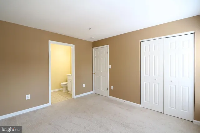 an empty room with closet area