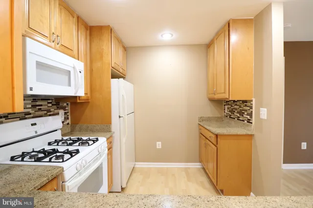 a kitchen with a stove a refrigerator and a stove