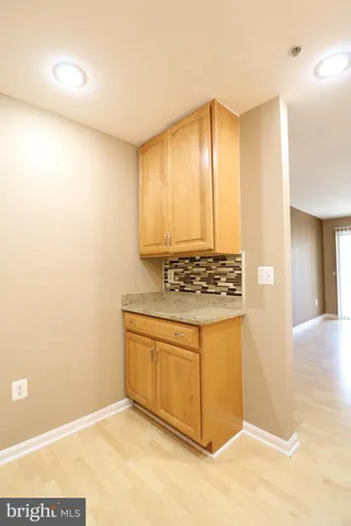 a view of kitchen with granite countertop cabinets and sink