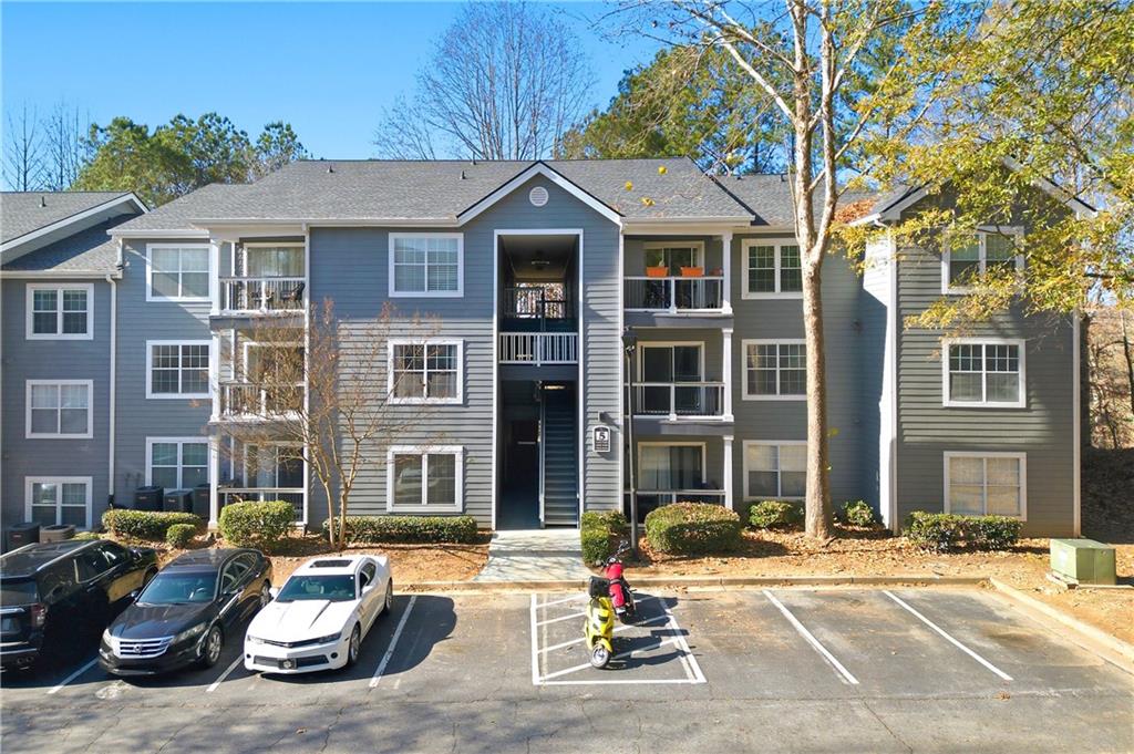 5205 Santa Fe Parkway Sandy Springs, GA 30350 - Photo 1 of 27 a front view of a residential apartment building with a yard