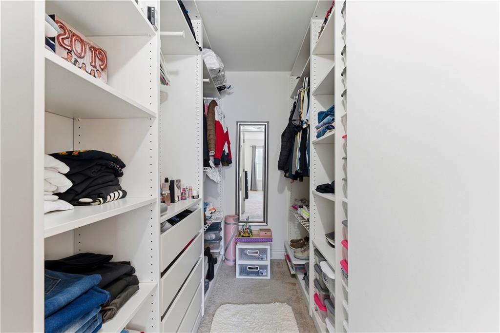 5205 Santa Fe Parkway Sandy Springs, GA 30350 - Photo 16 of 27 a view of walk in closet with clothes and shoes