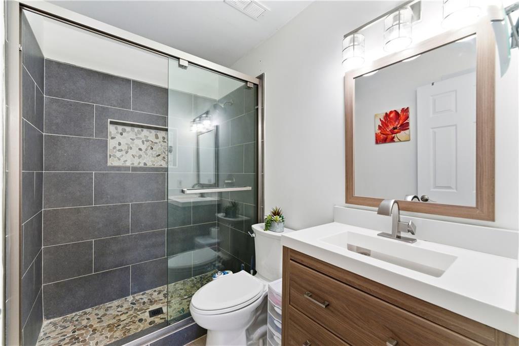 5205 Santa Fe Parkway Sandy Springs, GA 30350 - Photo 17 of 27 a bathroom with a sink a toilet and shower