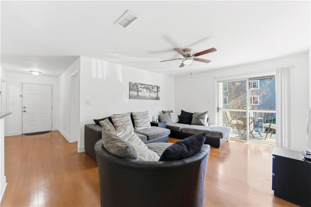 5205 Santa Fe Parkway Sandy Springs, GA 30350 - Photo 18 of 27 a living room with furniture and a large window with wooden floor
