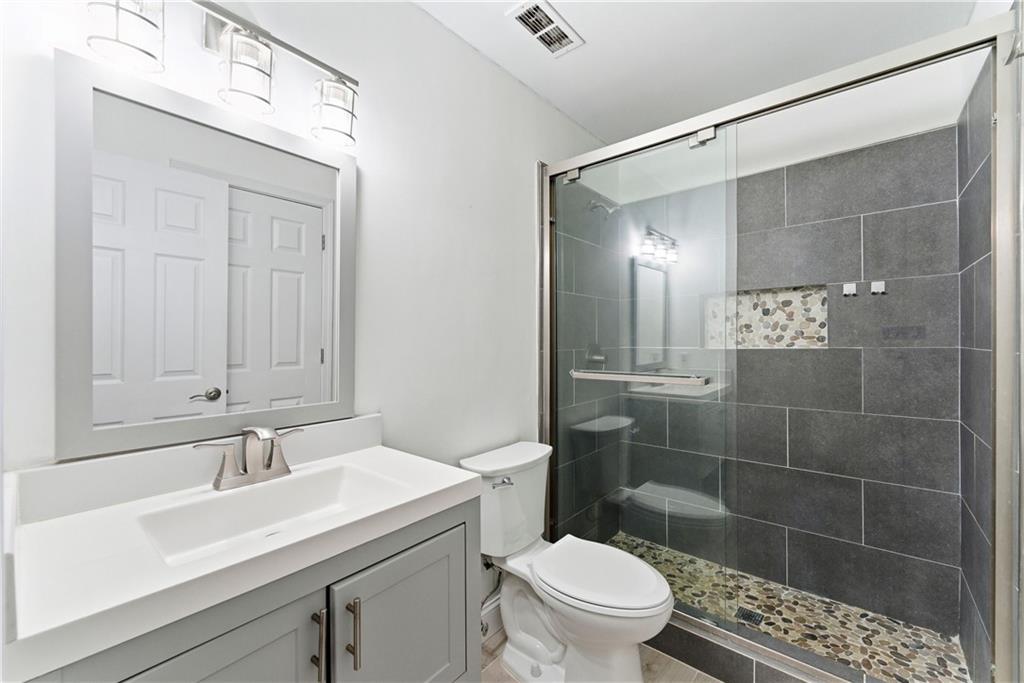 5205 Santa Fe Parkway Sandy Springs, GA 30350 - Photo 22 of 27 a bathroom with a sink a toilet and shower