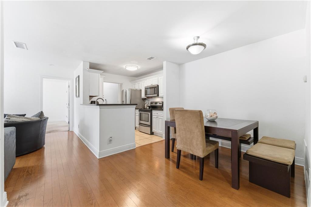 5205 Santa Fe Parkway Sandy Springs, GA 30350 - Photo 3 of 27 a kitchen with stainless steel appliances granite countertop a table chairs and a refrigerator