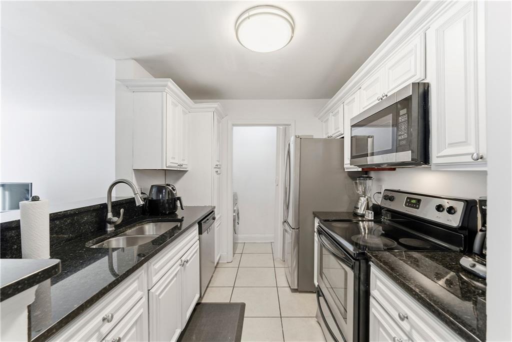 5205 Santa Fe Parkway Sandy Springs, GA 30350 - Photo 4 of 27 a kitchen with stainless steel appliances granite countertop a sink stove and refrigerator
