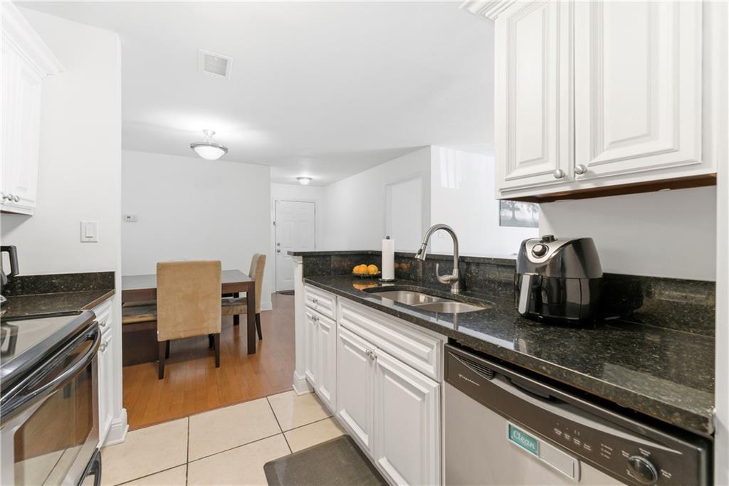 5205 Santa Fe Parkway Sandy Springs, GA 30350 - Photo 7 of 27 a kitchen with stainless steel appliances granite countertop a sink and cabinets