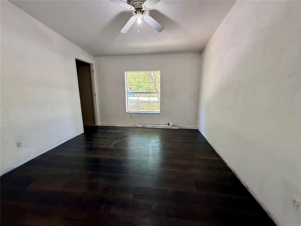 21471 Northwest 172nd Road High Springs, FL 32643 - Photo 14 of 26 an empty room with wooden floor and windows