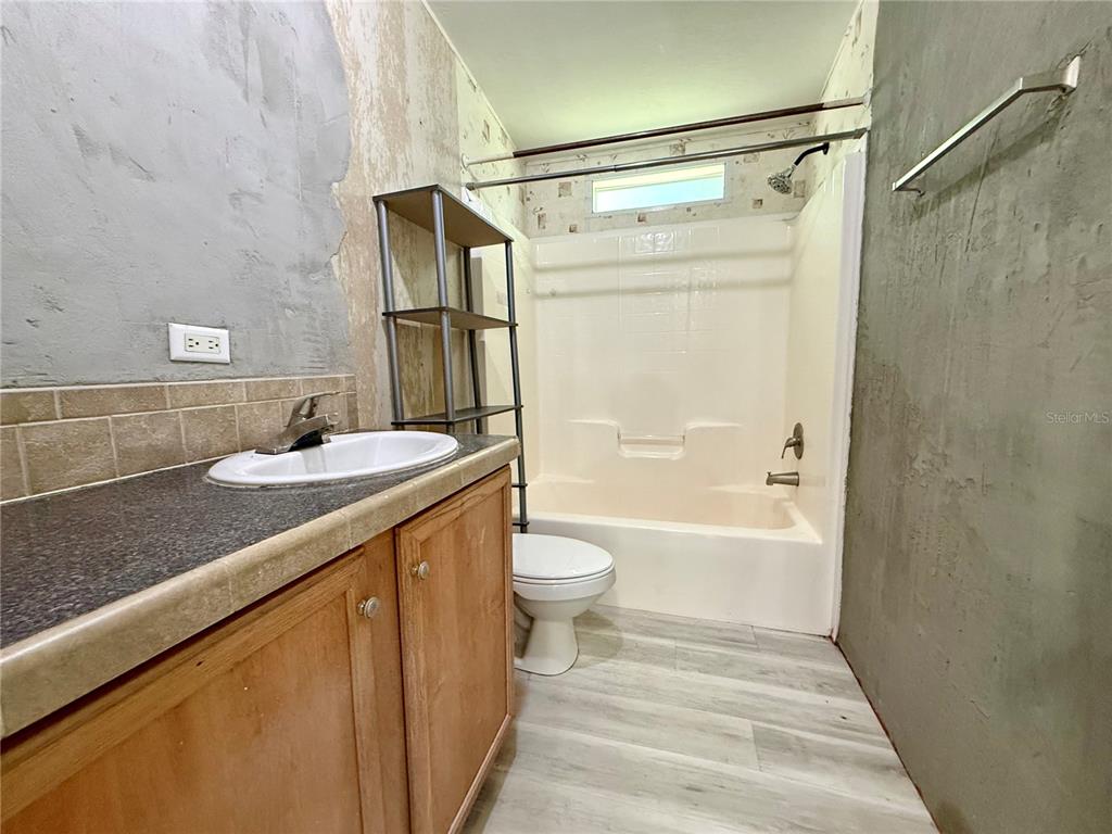 21471 Northwest 172nd Road High Springs, FL 32643 - Photo 16 of 26 a bathroom with a granite countertop sink toilet and shower