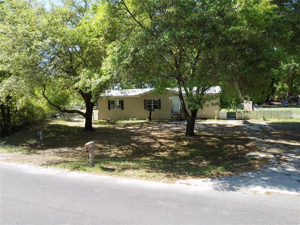 21471 Northwest 172nd Road High Springs, FL 32643 - Photo 25 of 26 a view of a street with a building and trees in the background