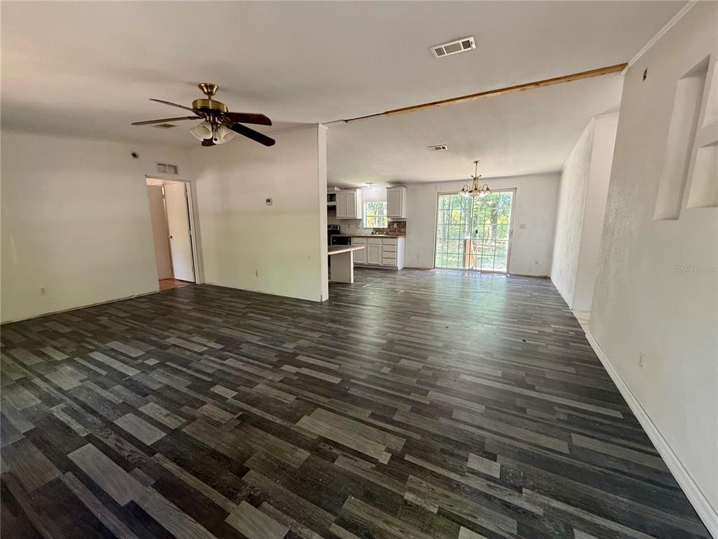21471 Northwest 172nd Road High Springs, FL 32643 - Photo 3 of 26 a view of an empty room with wooden floor and a window