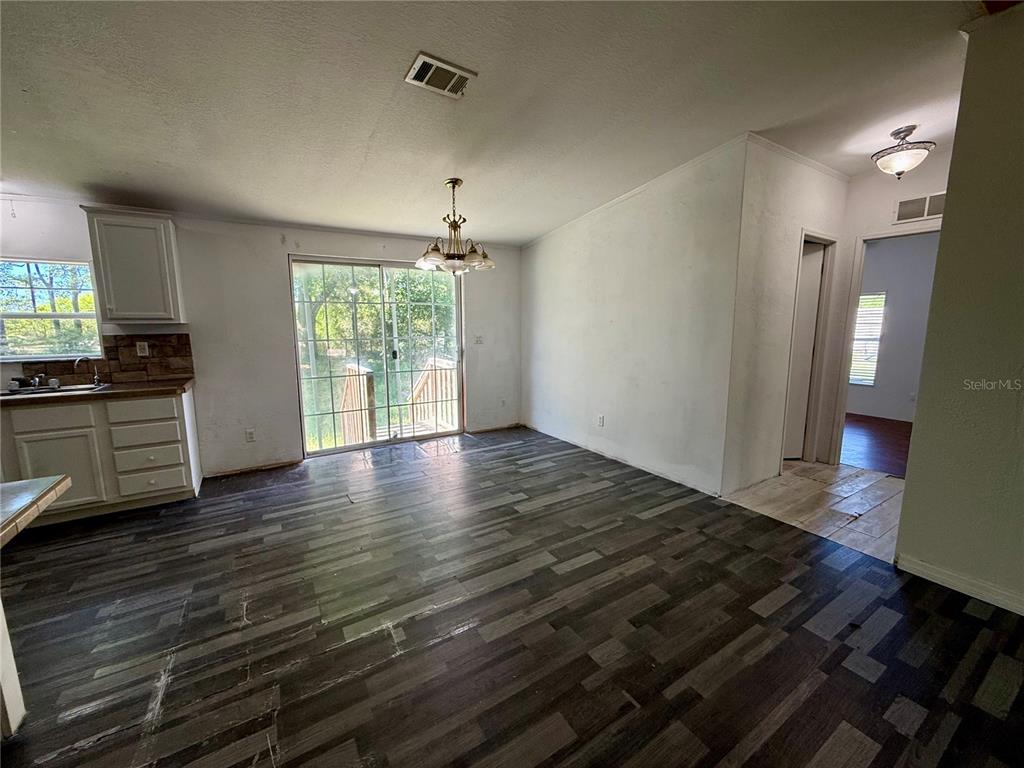 21471 Northwest 172nd Road High Springs, FL 32643 - Photo 7 of 26 a view of a room with wooden floor window and a kitchen