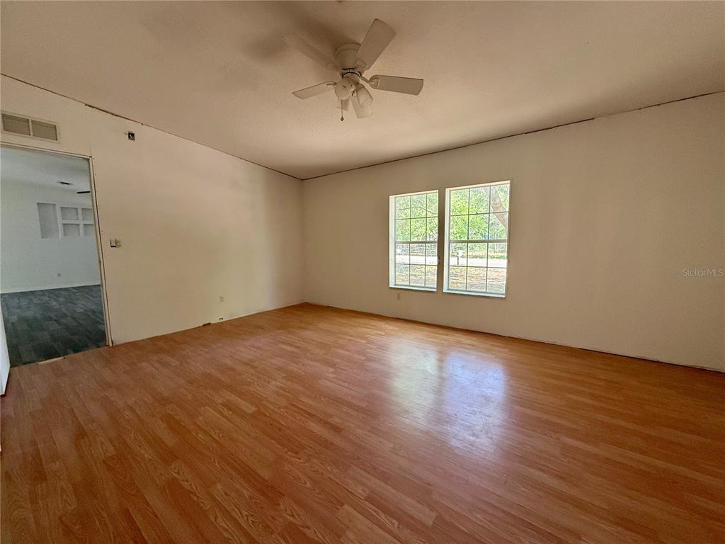 21471 Northwest 172nd Road High Springs, FL 32643 - Photo 9 of 26 wooden floor in an empty room with a window