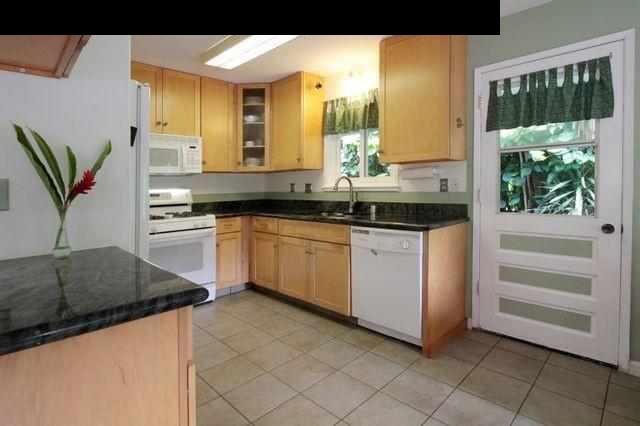 560 West Kuiaha Road Haiku, HI 96708 - Photo 11 of 23 a kitchen with a sink and cabinets