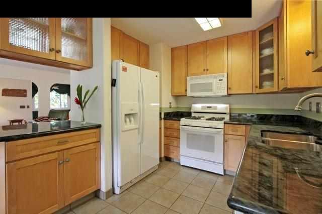 560 West Kuiaha Road Haiku, HI 96708 - Photo 10 of 23 a kitchen with stainless steel appliances a refrigerator sink and stove