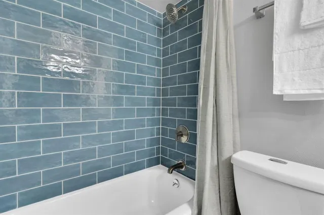 a bathroom with a bathtub and window