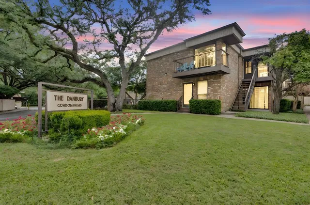 a view of a brick house with a yard