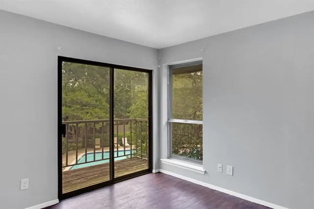 a view of an empty room with glass door