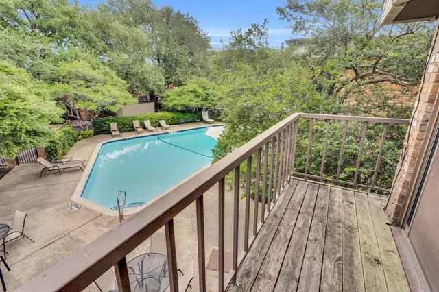 a view of balcony with wooden floor and fence