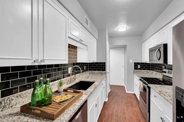 a kitchen with counter top space and stainless steel appliances