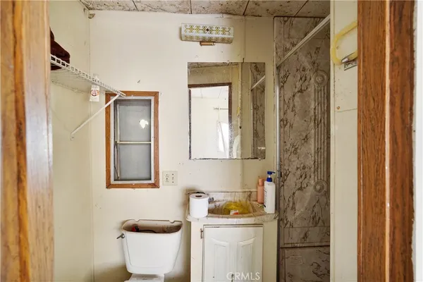 a bathroom with a toilet sink and shower