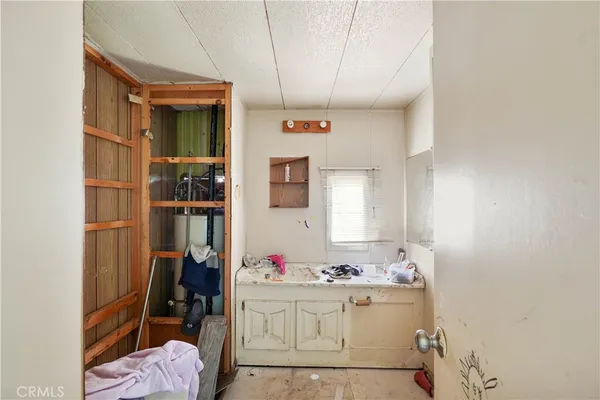 a bathroom with a sink vanity mirror and tub