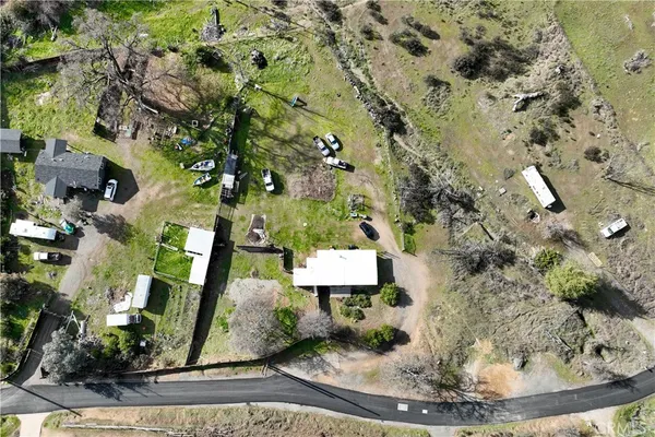 an aerial view of a house with a yard and fountain