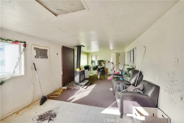 a living room with furniture a window and gym equipment