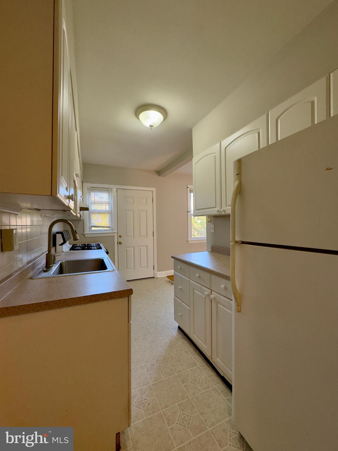 3710 Springwood Avenue Baltimore, MD 21206 - Photo 11 of 24 a kitchen with appliances a sink and a refrigerator