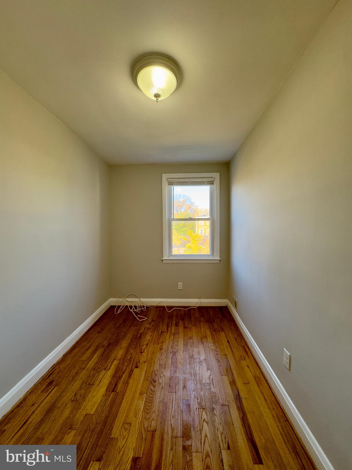3710 Springwood Avenue Baltimore, MD 21206 - Photo 19 of 24 an empty room with wooden floor and windows
