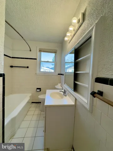 a view of a room with wooden floor and windows