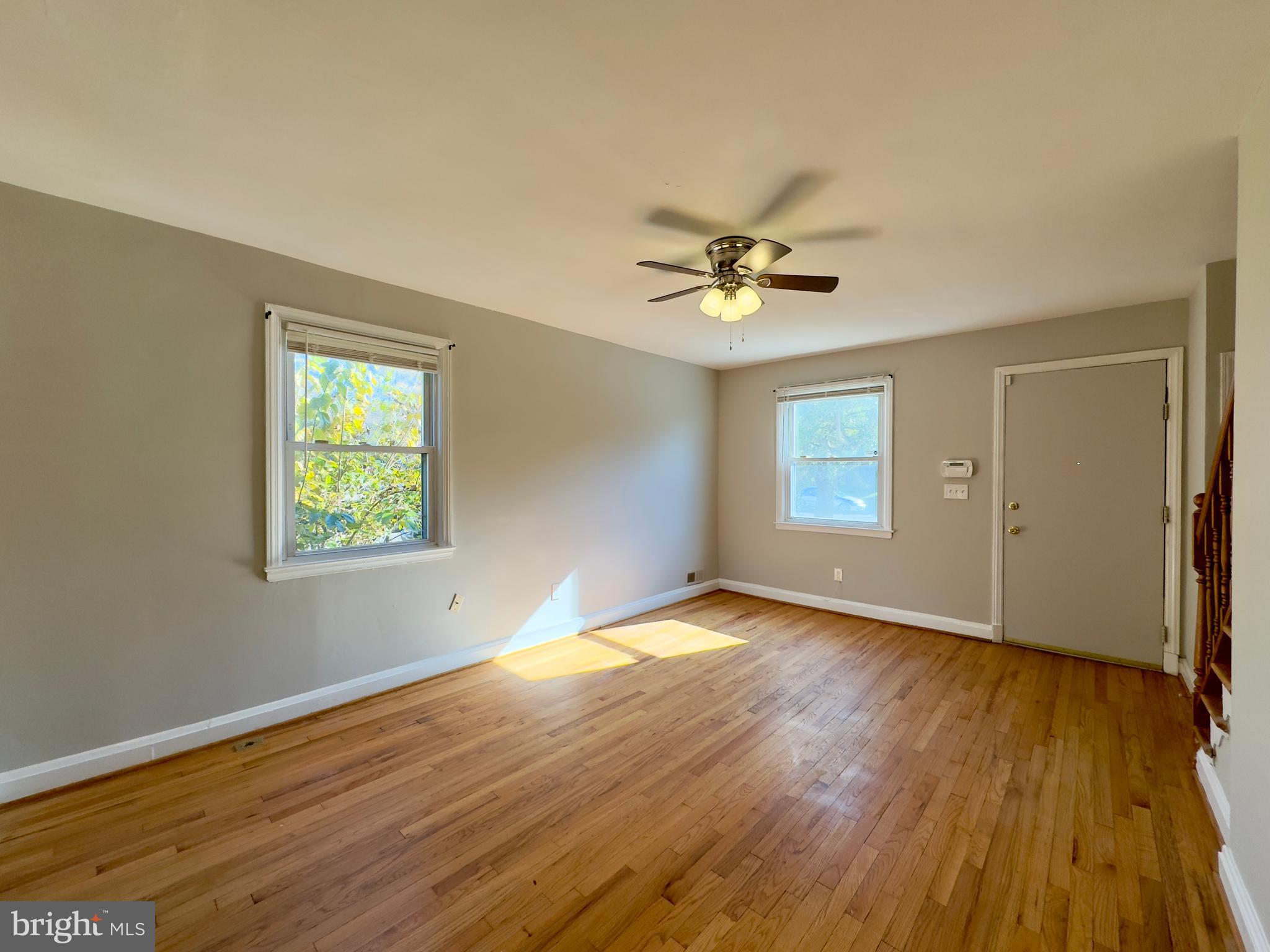 3710 Springwood Avenue Baltimore, MD 21206 - Photo 7 of 24 a view of an empty room with wooden floor and a window