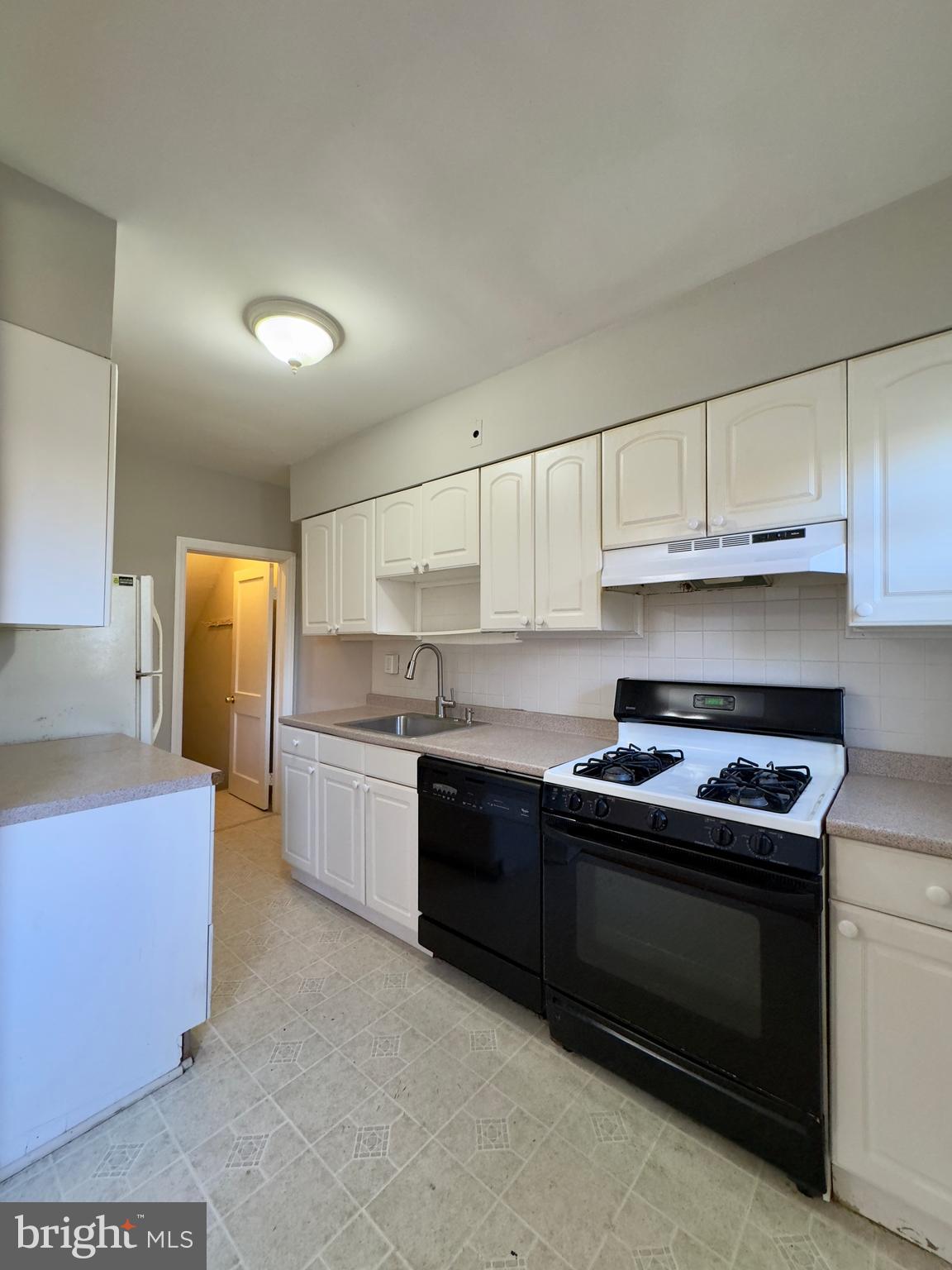 3710 Springwood Avenue Baltimore, MD 21206 - Photo 10 of 24 a kitchen with granite countertop a stove sink and cabinets