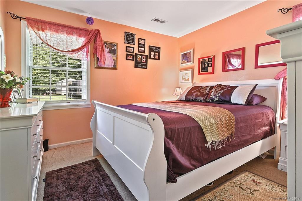 7101 Riding Trail Road, Unit 1 Charlotte, NC 28212 - Photo 6 of 14 a bedroom with a bed and a window
