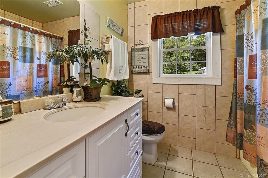 7101 Riding Trail Road, Unit 1 Charlotte, NC 28212 - Photo 7 of 14 a bathroom with a sink and a shower