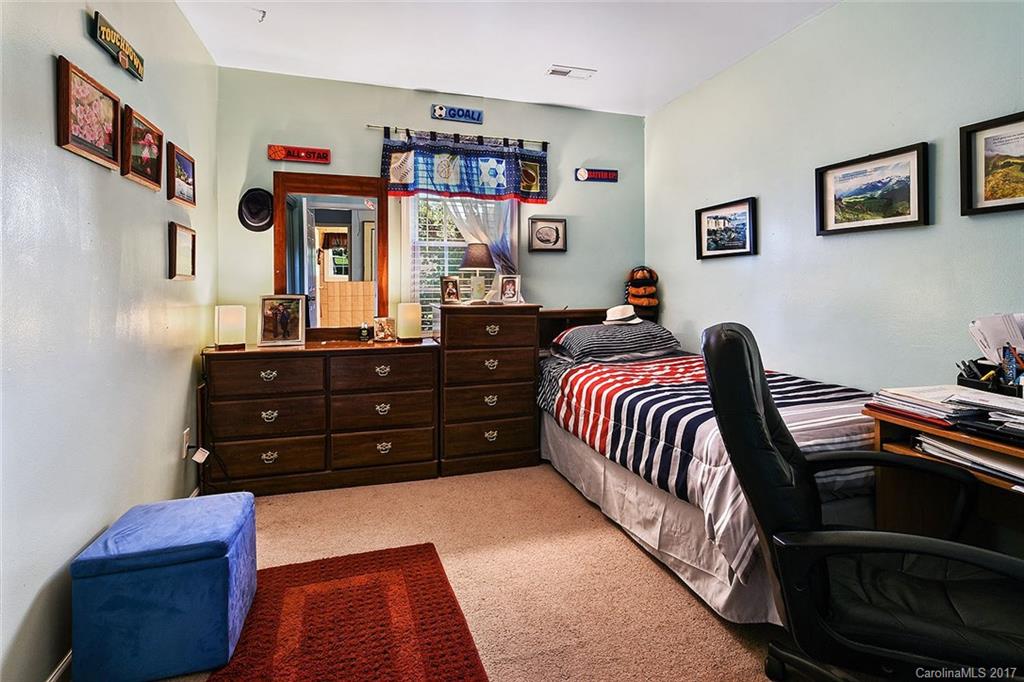 7101 Riding Trail Road, Unit 1 Charlotte, NC 28212 - Photo 8 of 14 a bedroom with a bed and a dresser