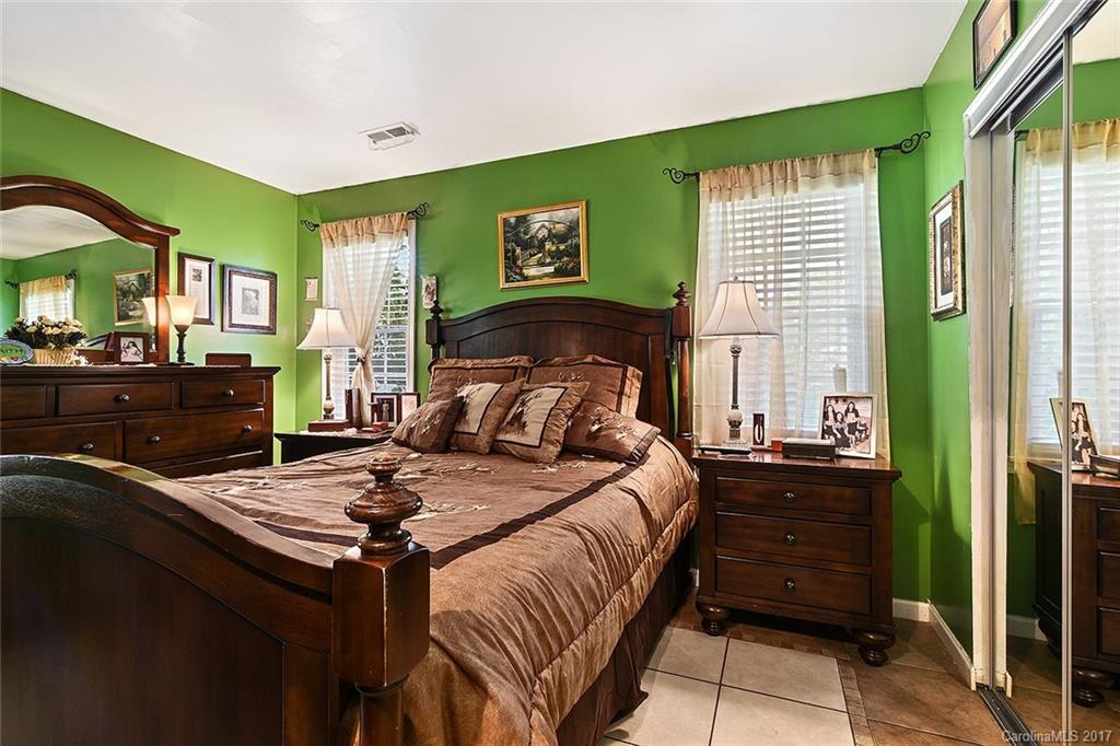 7101 Riding Trail Road, Unit 1 Charlotte, NC 28212 - Photo 9 of 14 a bedroom with a bed and a dresser next to a window